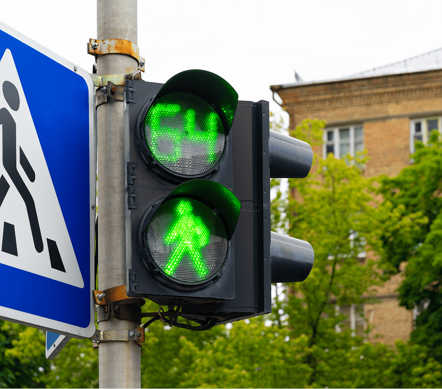 Green pedestrian traffic light with countdown timer.